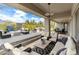 Expansive covered patio with comfortable seating areas, fire pit, and outdoor grill, creating a perfect outdoor living space at 6340 E Marioca Cir, Scottsdale, AZ 85266
