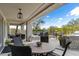 Covered outdoor patio features stylish seating, dining area, and an outdoor kitchen, ideal for entertaining guests at 6340 E Marioca Cir, Scottsdale, AZ 85266