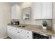 Wet bar with white cabinets, granite countertops, microwave, and wine refrigerator at 6340 E Marioca Cir, Scottsdale, AZ 85266