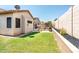 Expansive backyard featuring a well-maintained lawn and a sparkling pool, perfect for recreation at 6920 W Tether Trl, Peoria, AZ 85383