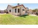 A spacious backyard with green lawn and a refreshing pool, creating an ideal outdoor retreat at 6920 W Tether Trl, Peoria, AZ 85383