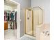 Bright bathroom featuring a glass-door shower, a soaking tub, and an open walk-in closet with custom shelving at 6920 W Tether Trl, Peoria, AZ 85383