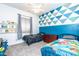 Fun bedroom with colorful accents, two twin beds, a ceiling fan, and natural light at 6920 W Tether Trl, Peoria, AZ 85383