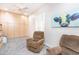 Inviting bonus room with two recliners, carpet, storage, and natural light creating a cozy retreat at 6920 W Tether Trl, Peoria, AZ 85383