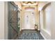 Inviting foyer with a decorative light fixture, beautiful door with glass, shutters, and a sliding barn door at 6920 W Tether Trl, Peoria, AZ 85383