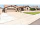 Single-Gathering home with a 2-car garage, long driveway, and attractive landscaping at 6920 W Tether Trl, Peoria, AZ 85383