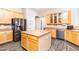 Functional kitchen design featuring a central island, updated appliances, and efficient layout at 6920 W Tether Trl, Peoria, AZ 85383