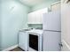 Well-equipped laundry room with washer, dryer, refrigerator and ample storage cabinets at 6920 W Tether Trl, Peoria, AZ 85383