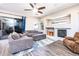 Relaxing living area with a fireplace, comfortable seating, and seamless indoor-outdoor flow at 6920 W Tether Trl, Peoria, AZ 85383