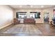 Open-concept living room with modern wood-look flooring, a stylish rug and neutral paint at 6920 W Tether Trl, Peoria, AZ 85383