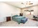 Comfortable bedroom featuring a plush bed, carpeting, and a bright window at 6920 W Tether Trl, Peoria, AZ 85383