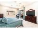 Well-lit bedroom with a large bed, dark wood dresser, and access to a patio at 6920 W Tether Trl, Peoria, AZ 85383