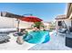 Inviting backyard pool with rock waterfall, covered seating, and a relaxing atmosphere at 6920 W Tether Trl, Peoria, AZ 85383