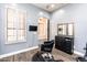 Salon space featuring black styling chairs, a mirror, wood-look flooring and natural light from shuttered windows at 6920 W Tether Trl, Peoria, AZ 85383