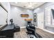 Salon space featuring black styling chairs, a mirror, a sink, wood-look flooring and natural light from shuttered windows at 6920 W Tether Trl, Peoria, AZ 85383
