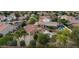 Overhead view of a house with a pool, patio, and mature trees in a residential neighborhood at 7015 S Stadium Ct, Gilbert, AZ 85298