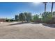 Spacious backyard with mature trees and a vast gravel area at 7015 S Stadium Ct, Gilbert, AZ 85298