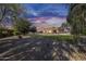 Expansive backyard with a pool, seating, lush lawn and desert landscaping at 7015 S Stadium Ct, Gilbert, AZ 85298