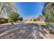 Expansive backyard featuring a green lawn, gravel area, and in-ground pool at 7015 S Stadium Ct, Gilbert, AZ 85298