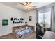 Cozy bedroom featuring a ceiling fan, unique decor, and a comfortable-looking bed with a plaid comforter at 7015 S Stadium Ct, Gilbert, AZ 85298