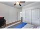 Bedroom featuring closet, a door to another room, and a bed with blue and gray bedding at 7015 S Stadium Ct, Gilbert, AZ 85298