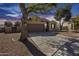 Charming home featuring a well-maintained lawn, mature trees, and an attached two-car garage at 7015 S Stadium Ct, Gilbert, AZ 85298
