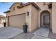 Close up of home exterior with arched entrance and two car garage at 7015 S Stadium Ct, Gilbert, AZ 85298