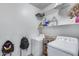 Functional laundry room with washer, dryer, and storage shelves, offering practical convenience at 7015 S Stadium Ct, Gilbert, AZ 85298