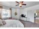 Cozy main bedroom with a ceiling fan, TV, and elegant decor for a relaxing retreat at 7015 S Stadium Ct, Gilbert, AZ 85298