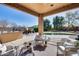 Covered patio featuring comfortable seating, string lights, and a view of the pool and backyard at 7015 S Stadium Ct, Gilbert, AZ 85298