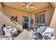 Cozy covered patio with comfortable seating, string lights, and easy access to the indoor living space at 7015 S Stadium Ct, Gilbert, AZ 85298