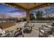 Comfortable outdoor living space with string lights, plush seating, and a built-in barbecue at 7015 S Stadium Ct, Gilbert, AZ 85298