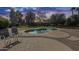 Relaxing pool with ample seating and a lush green yard, ideal for hot summer days at 7015 S Stadium Ct, Gilbert, AZ 85298