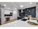 This modern kitchen features white cabinets and a built-in desk alongside stainless steel appliances and unique backsplash at 7151 E Rancho Vista Dr # 2006, Scottsdale, AZ 85251