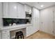 This additional counter space is an extension to the kitchen and has a small desk, white cabinets and stainless microwave at 7151 E Rancho Vista Dr # 2006, Scottsdale, AZ 85251
