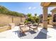 Landscaped backyard with a cozy seating area and lush green foliage at 7739 E Evening Glow Dr, Scottsdale, AZ 85266
