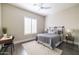 Stylish bedroom featuring a comfortable bed, a work space, and shutters providing ample natural light at 7739 E Evening Glow Dr, Scottsdale, AZ 85266