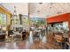 Cafe area with tables, chairs, and a fireplace, featuring large windows with scenic desert mountain views at 7739 E Evening Glow Dr, Scottsdale, AZ 85266