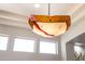 Unique light fixture hanging from the ceiling with three windows in the background at 7739 E Evening Glow Dr, Scottsdale, AZ 85266