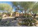 Beautiful desert landscaping and a charming one-story home are showcased in this front yard view at 7739 E Evening Glow Dr, Scottsdale, AZ 85266