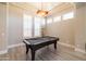A game room featuring a black felt pool table with white plantation shutters at 7739 E Evening Glow Dr, Scottsdale, AZ 85266