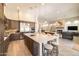 The kitchen features an island with seating, pendant lighting, stainless appliances, and an open layout to the living room at 7739 E Evening Glow Dr, Scottsdale, AZ 85266