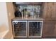 This sophisticated bar area is complete with a wine cooler, stemware racks, and stone countertops at 7739 E Evening Glow Dr, Scottsdale, AZ 85266