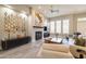 Comfortable living room featuring a fireplace, ceiling fan, and large windows at 7739 E Evening Glow Dr, Scottsdale, AZ 85266