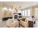 Bright living room boasts a fireplace, ceiling fan, and neutral colors, perfect for relaxation and entertaining guests at 7739 E Evening Glow Dr, Scottsdale, AZ 85266