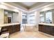 Luxurious bathroom featuring dual vanities, a modern soaking tub, and bright natural light at 7739 E Evening Glow Dr, Scottsdale, AZ 85266