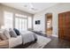 Inviting main bedroom with large windows, bench seating and dark wood floors, offering plenty of natural light at 7739 E Evening Glow Dr, Scottsdale, AZ 85266