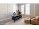 An office space with a white rug, white wainscoting, and plantation shutters at 7739 E Evening Glow Dr, Scottsdale, AZ 85266