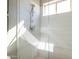 Bright shower features white tiling, glass enclosure, and a built-in seat, illuminated by a natural light window at 7739 E Evening Glow Dr, Scottsdale, AZ 85266