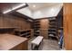 Custom walk-in closet providing ample storage with shelving, drawers, and stylish lighting at 7739 E Evening Glow Dr, Scottsdale, AZ 85266